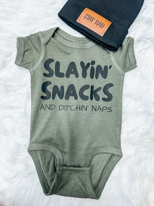 slayin’ snacks and ditchin’ naps onesie ⚡︎